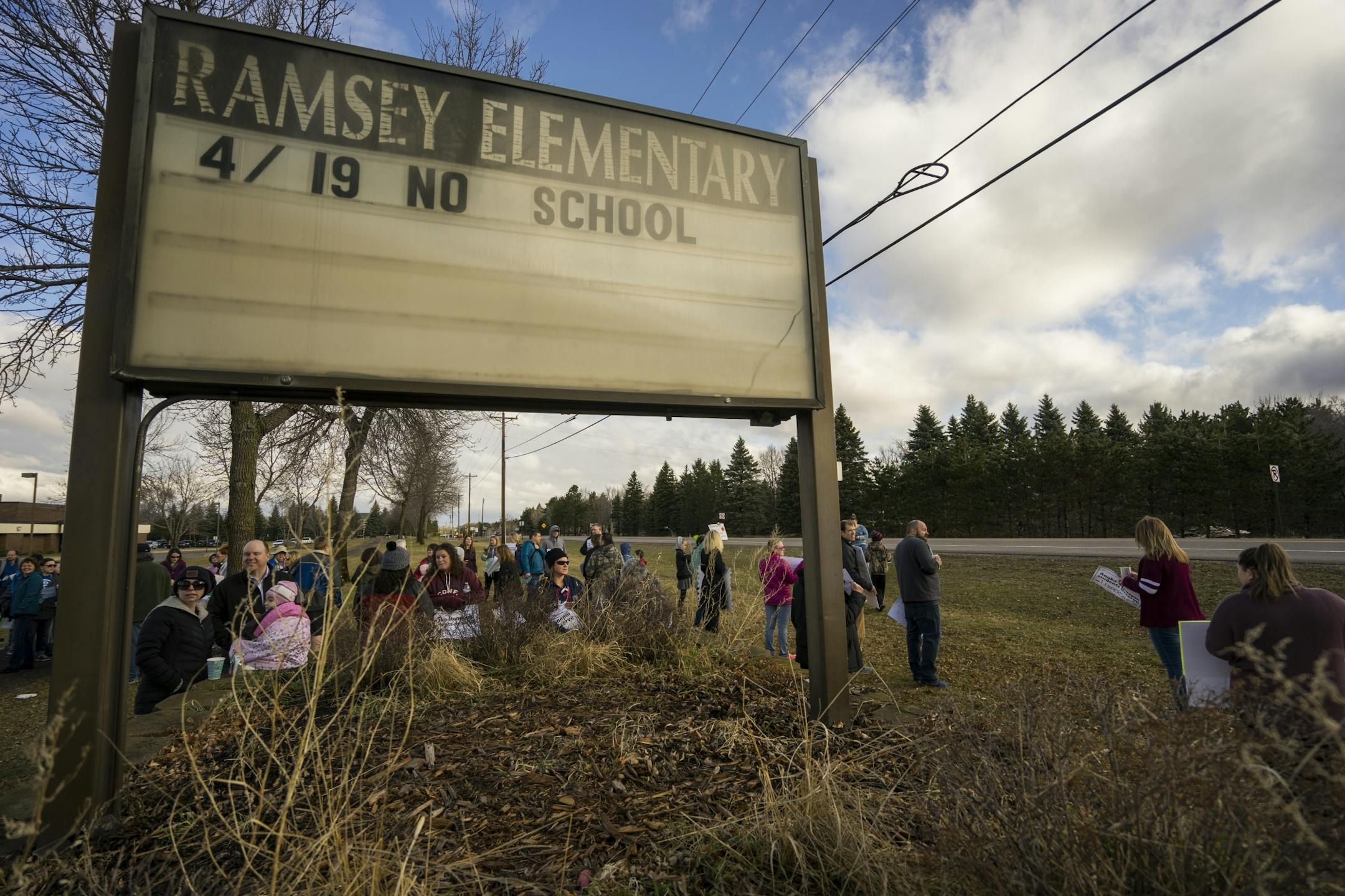 Students, parents and faculty demonstrated a walk in on Thursday, April 18, 2018 outside of Ramsey Elementary School in Ramsey, Minn.