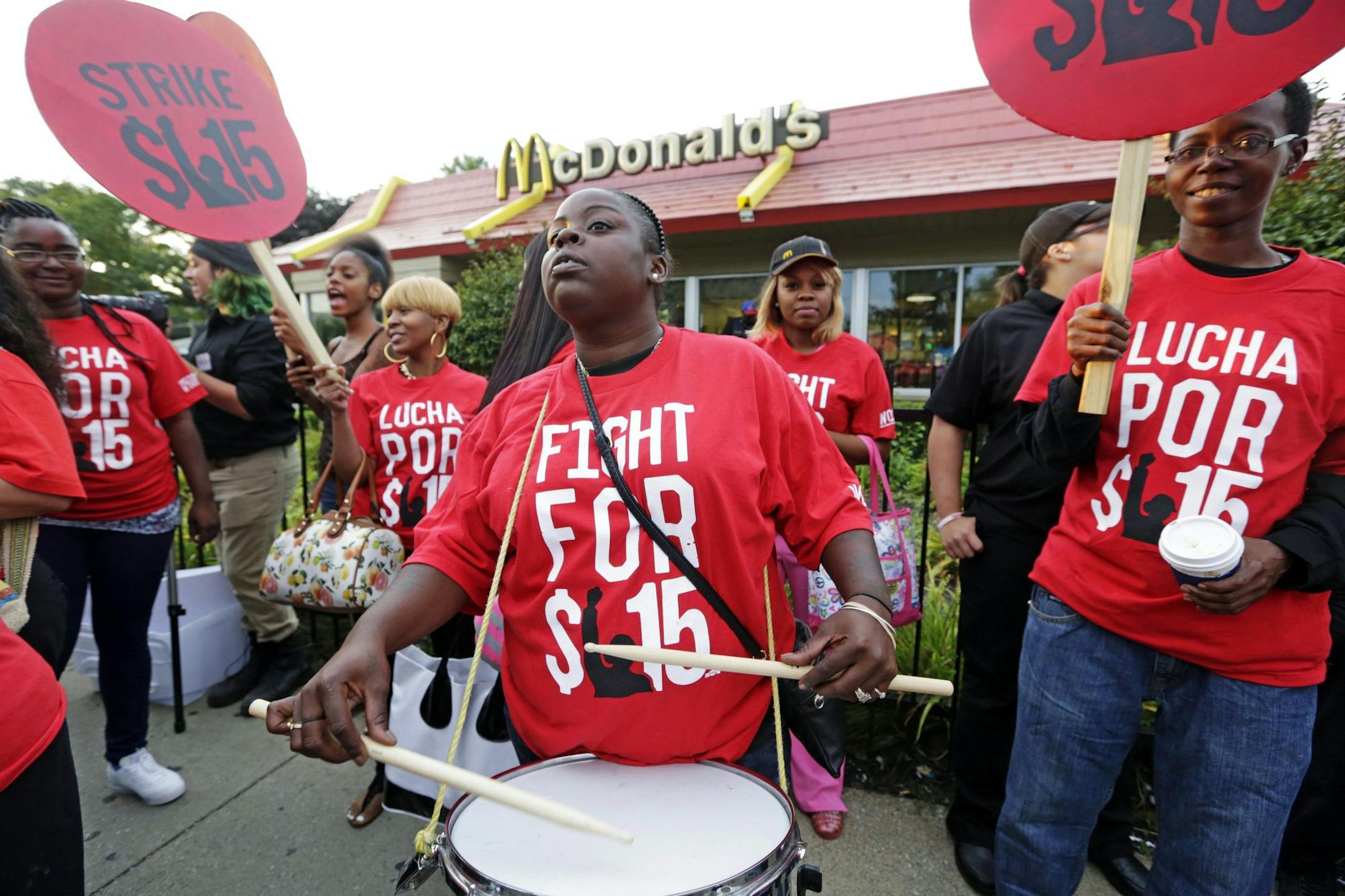 FILE - In this Sept. 4, 2014 file photo, Carmalita Johnson drums as protesters participate in a rally outside a McDonaldís on Chicago's south side as labor organizers escalate their campaign to unionize the industry's workers. Franchise owners wonder whether theyíll lose autonomy as a result of hearings into about 80 charges against McDonaldís and some of its franchisees. (AP Photo/M. Spencer Green, File) ORG XMIT: NYBZ108
