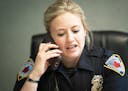 Officer Ashley Bergeron talked with another officer on the phone before a meeting with a paramedic from the mental health unit to discuss a case in Ma
