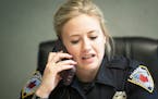 Officer Ashley Bergeron talked with another officer on the phone before a meeting with a paramedic from the mental health unit to discuss a case in Ma