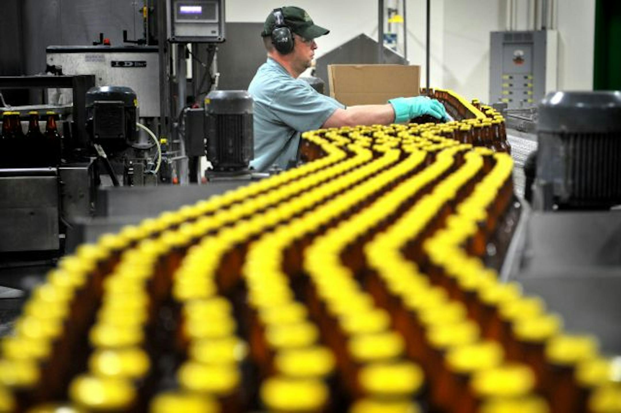 Scott Alewine checked quality along the bottling line of Hefe Weizen beer at Summit Brewing Co. of St. Paul.