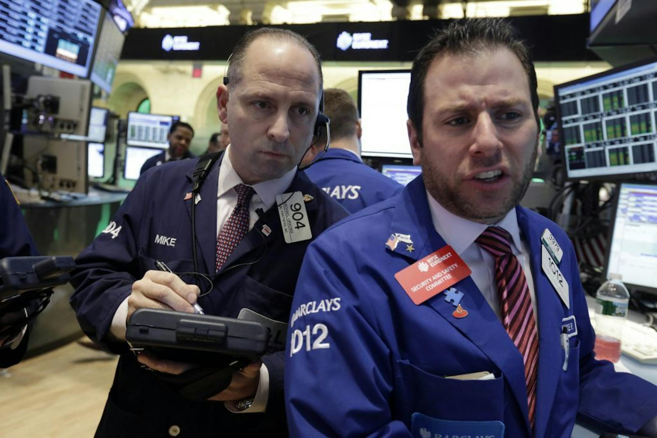 Trader Michael Urkonis, left, and specialist Michael Pistillo work on the floor of the New York Stock Exchange Tuesday, Jan. 29, 2013. Stocks opened mixed on Wall Street, with the Standard & Poor's 500 holding at 1,500.