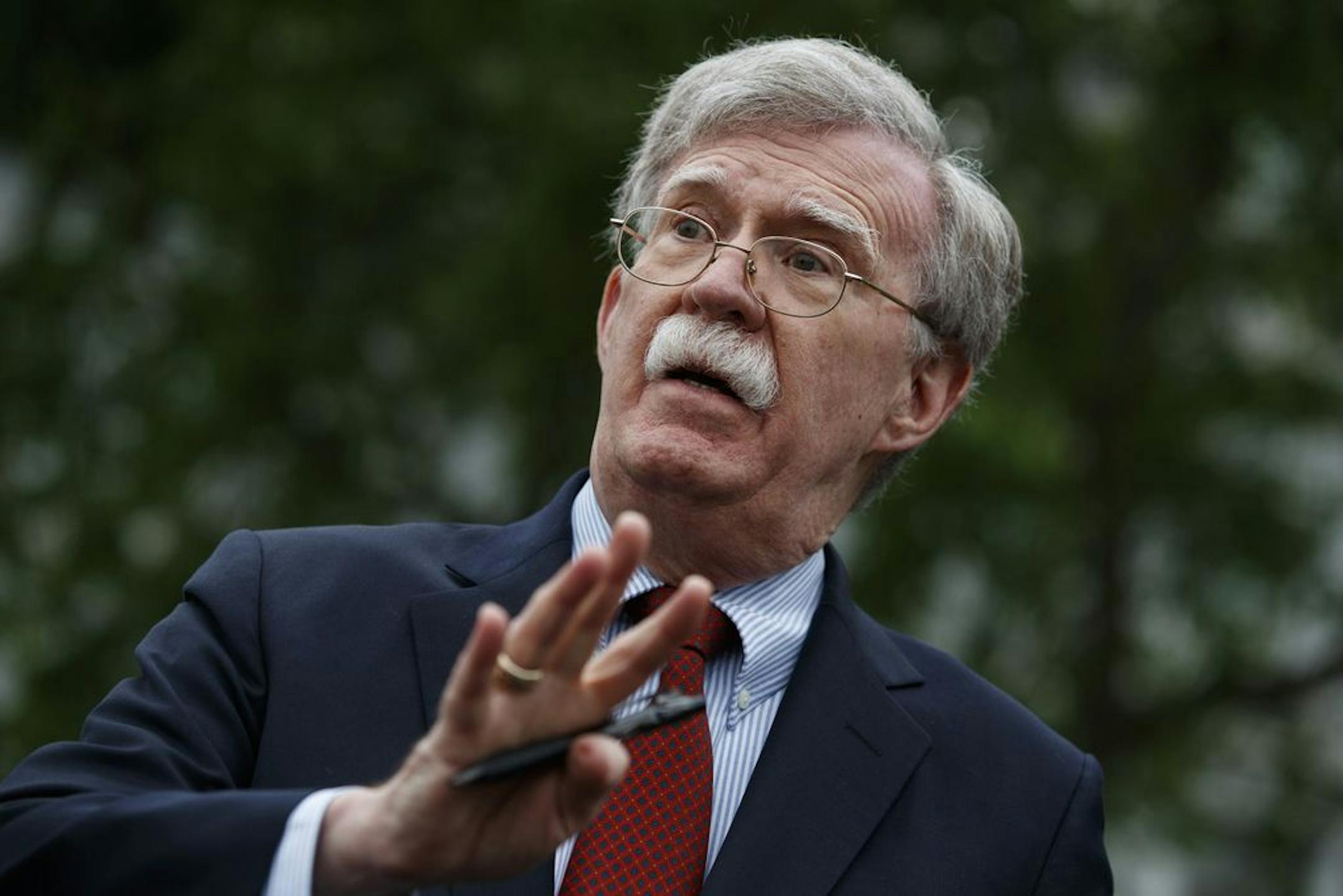 FILE - In this May 1, 2019 file photo, National security adviser John Bolton talks to reporters outside the White House in Washington. Trump says he fired national security adviser John Bolton, says they 'disagreed strongly' on many issues.