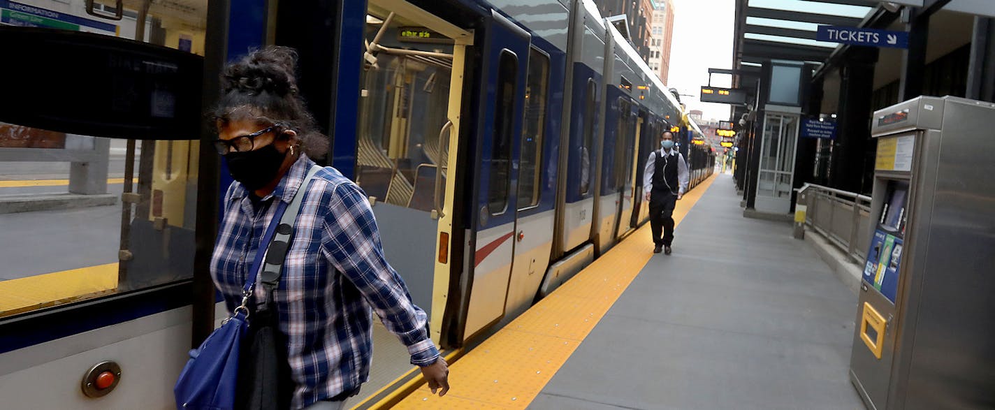 Commuters disembark from a light rail train at the Nicollet Mall station during the morning rush hour Tuesday, June 23, 2020, in Minneapolis.