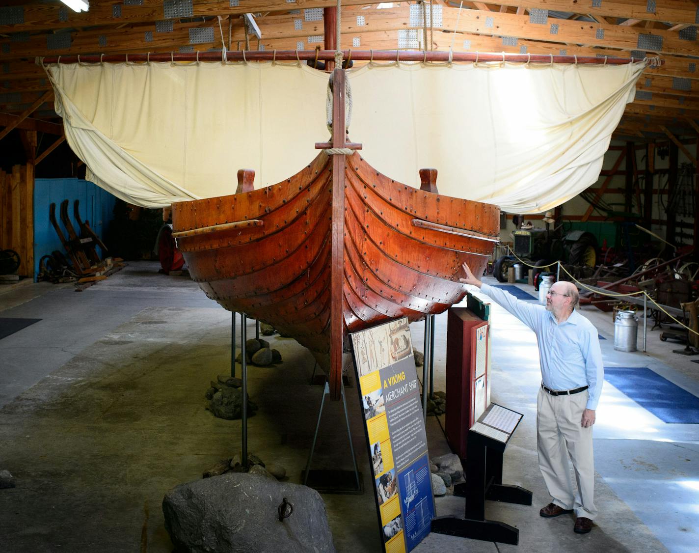 Jim Bergquist, executive director of the Runestone Museum, shows off a replica Viking ship.