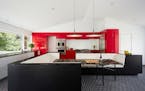Red cabinets make a statement in a kitchen designed by architect Ben Awes.