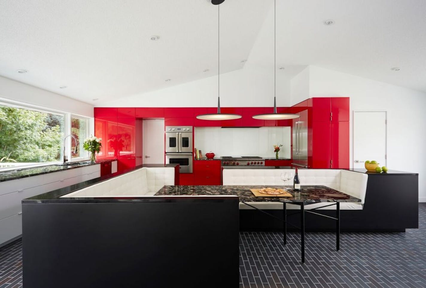 Red cabinets make a statement in a kitchen designed by architect Ben Awes.