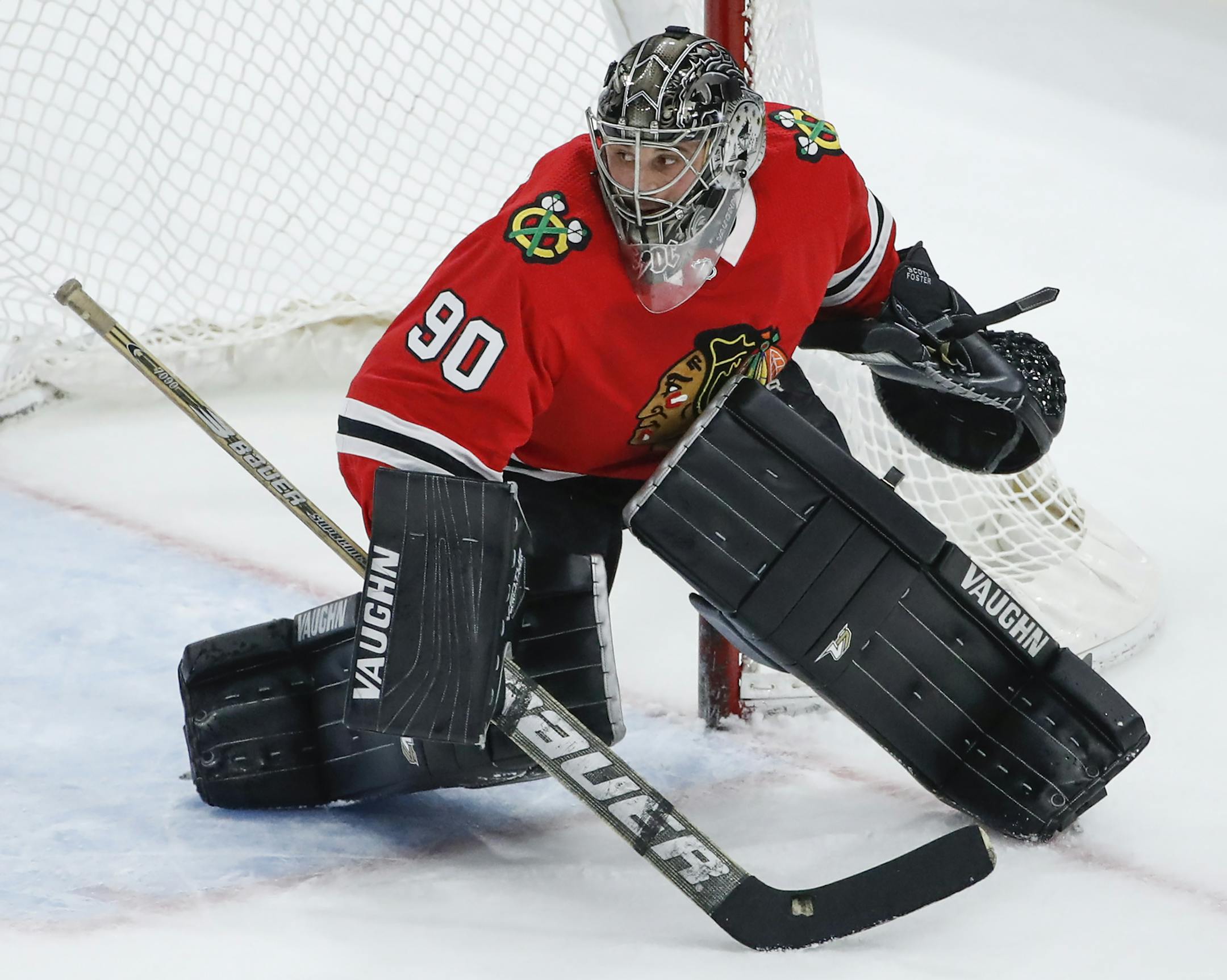 Chicago Blackhawks goalie Scott Foster defends against the Winnipeg Jets during the third period of an NHL hockey game Thursday, March 29, 2018, in Chicago. (AP Photo/Kamil Krzaczynski)