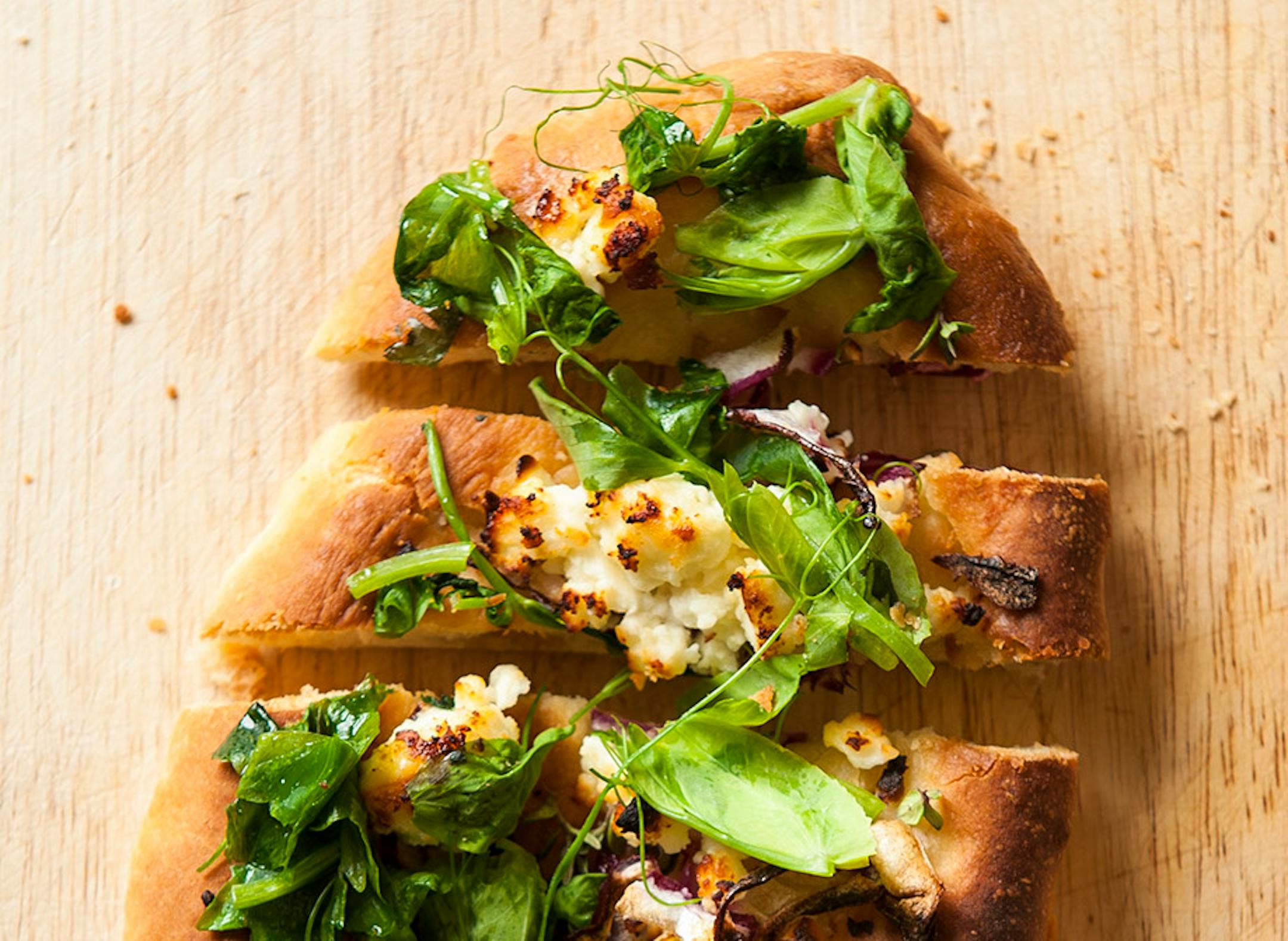 Naan With Red Onion, Feta and Pea Shoots.