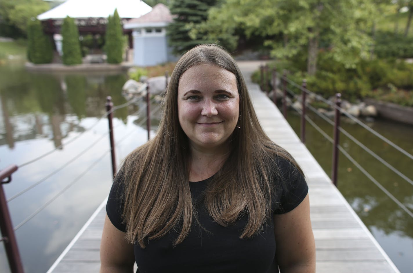 Donna Devine, who had breast cancer 12 years ago, stood on the foot bridge at Centenial Lakes Park in Edina, Min., Tuesday, August 27, 2013. Devine was a part of state's high risk pool, but soon will move to the MNSure exchange. ] (KYNDELL HARKNESS/STAR TRIBUNE) kyndell.harkness@startribune.com