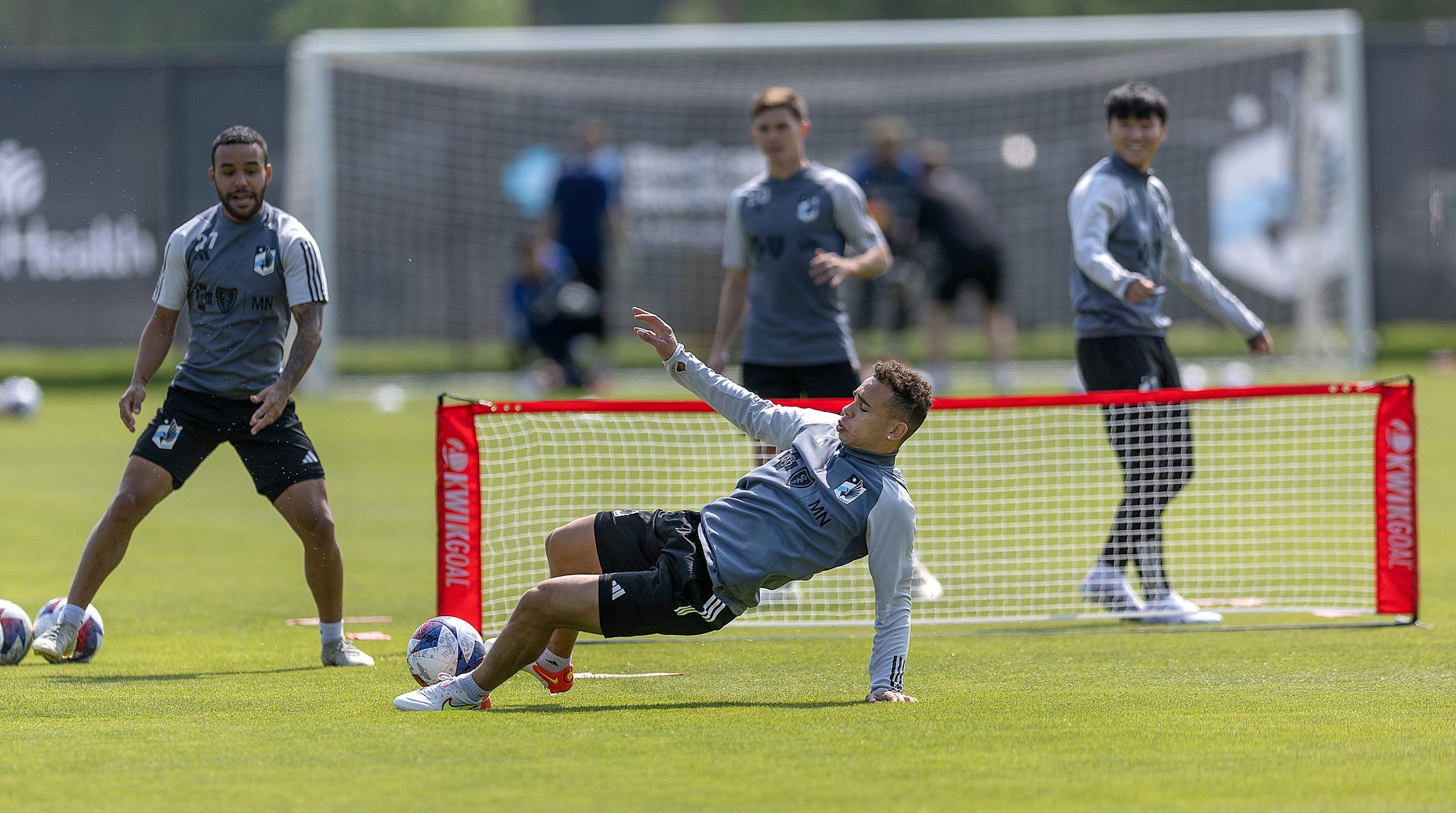 Minnesota United players including midfielder Hassani Dotson, center, practices.