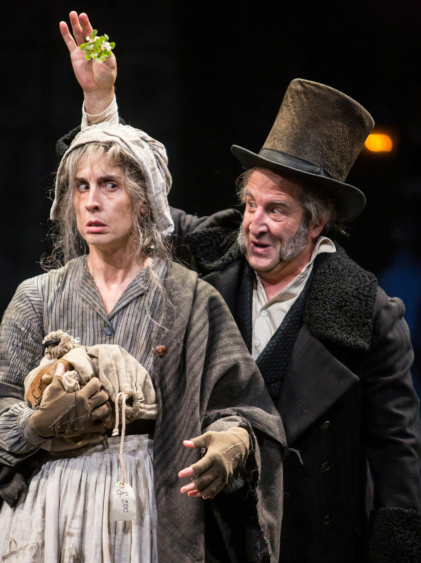 Angela Timberman (Merriweather) and J.C. Cutler (Ebenezer Scrooge) in the Guthrie Theater's 41st annual production of the Charles Dickens classic, A Christmas Carol, adapted by Crispin Whittell and directed by Joe Chvala with set design by Walt Spangler, costume design by Mathew J. LeFebvre and lighting design by Christopher Akerlind. November 12 - December 27, 2015 on the Wurtele Thrust Stage at the Guthrie Theater, Minneapolis. Photo by Dan Norman.