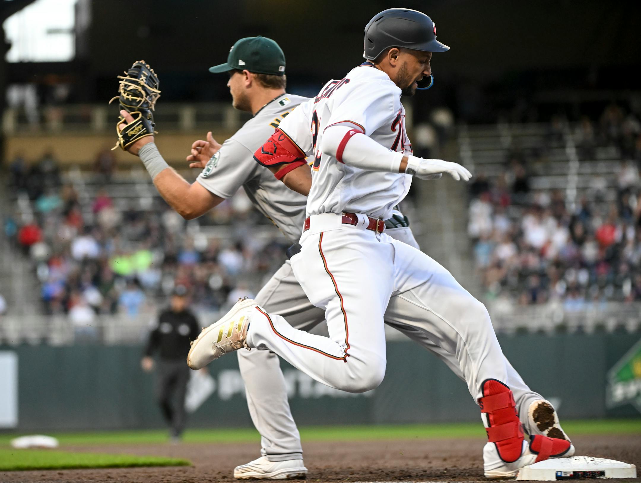 Minnesota Twins shortstop Royce Lewis (23) is out at first as Oakland Athletics first baseman Sheldon Neuse (26) makes the tag in the bottom of the second inning.