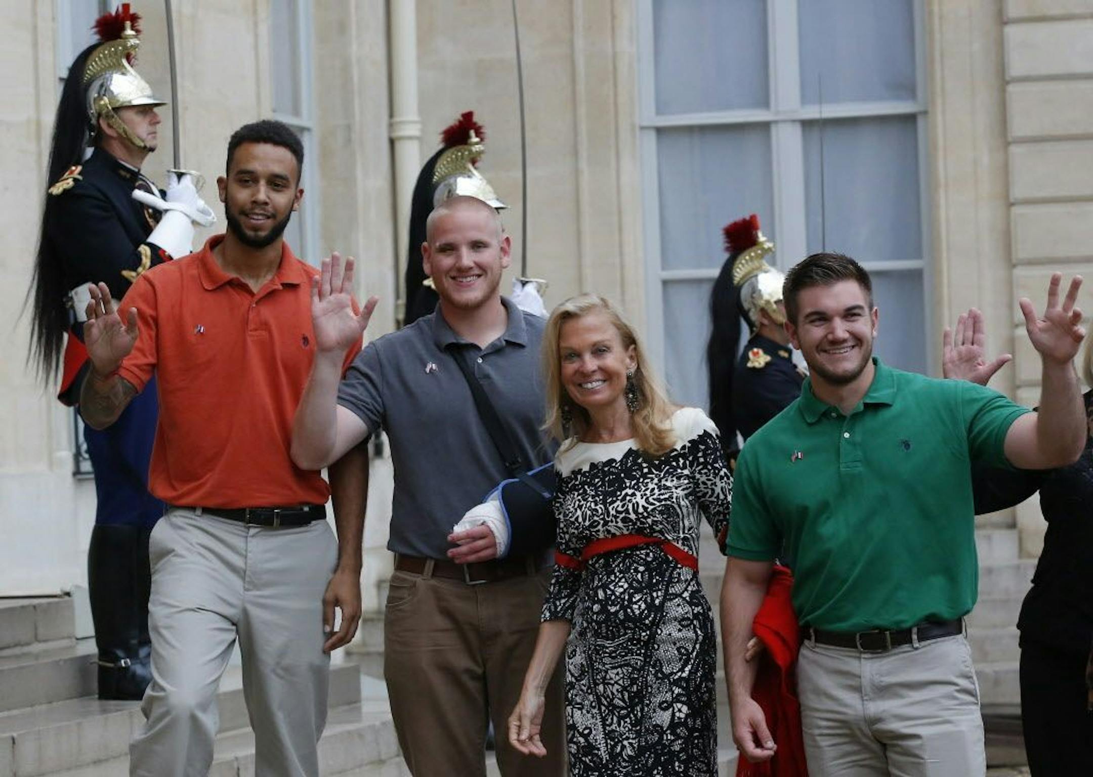 From the left, Anthony Sadler, a senior at Sacramento University in California, U.S. Airman Spencer Stone, U.S. Ambassador to France Jane D. Hartley and U.S. National Guardsman from Roseburg, Oregon, Alek Skarlatos, right, arrive at the Elysee Palace, Monday Aug.24, 2015 in Paris.