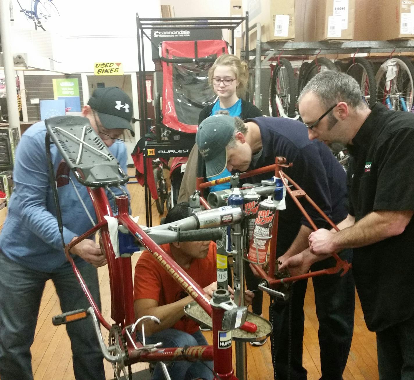 Volunteers work on red bikes for Austin Minn.'s bike sharing program