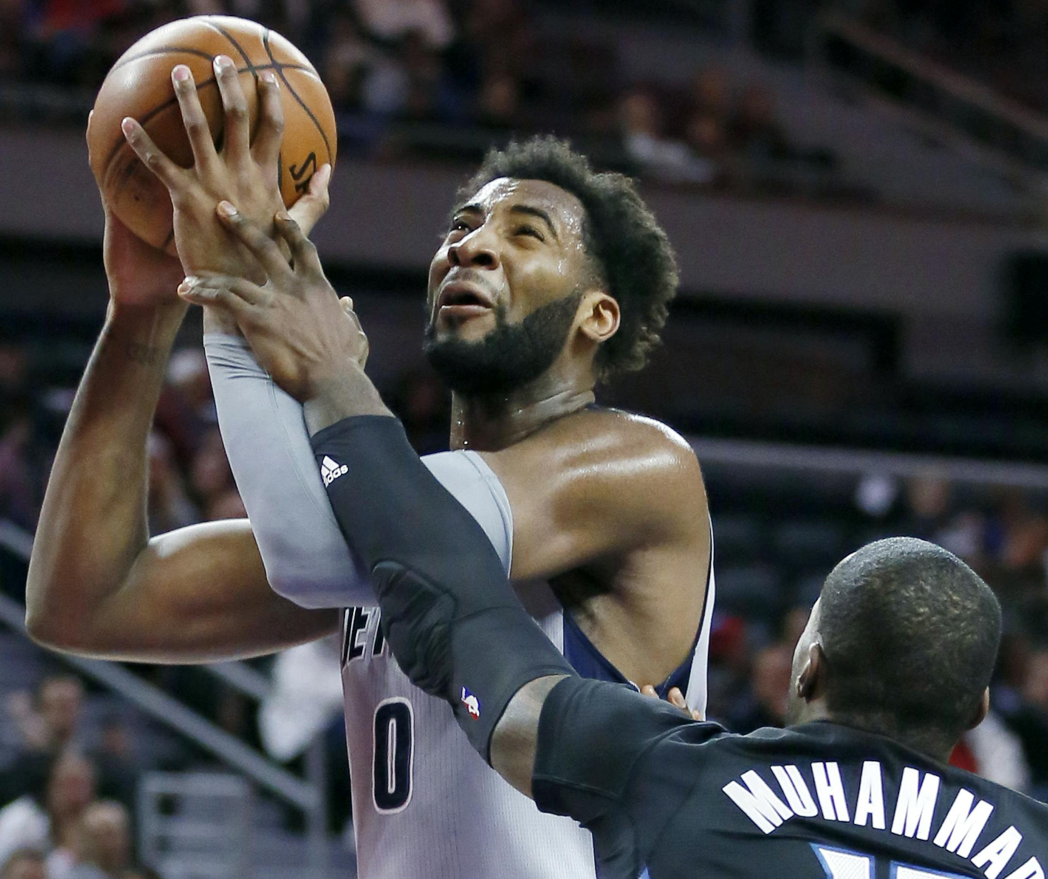 Detroit Pistons&#x2019; Andre Drummond (0) is fouled while going to the basket against Minnesota Timberwolves&#x2019; Shabazz Muhammad (15) during the first half of an NBA basketball game Thursday, Dec. 31, 2015, in Auburn Hills, Mich. (AP Photo/Duane Burleson)