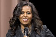 Former first lady Michelle Obama speaks to the audience during a stop on her book tour for "Becoming," in Washington on Sunday, Nov. 25, 2018. (AP Pho