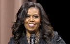 Former first lady Michelle Obama speaks to the audience during a stop on her book tour for "Becoming," in Washington on Sunday, Nov. 25, 2018. (AP Pho