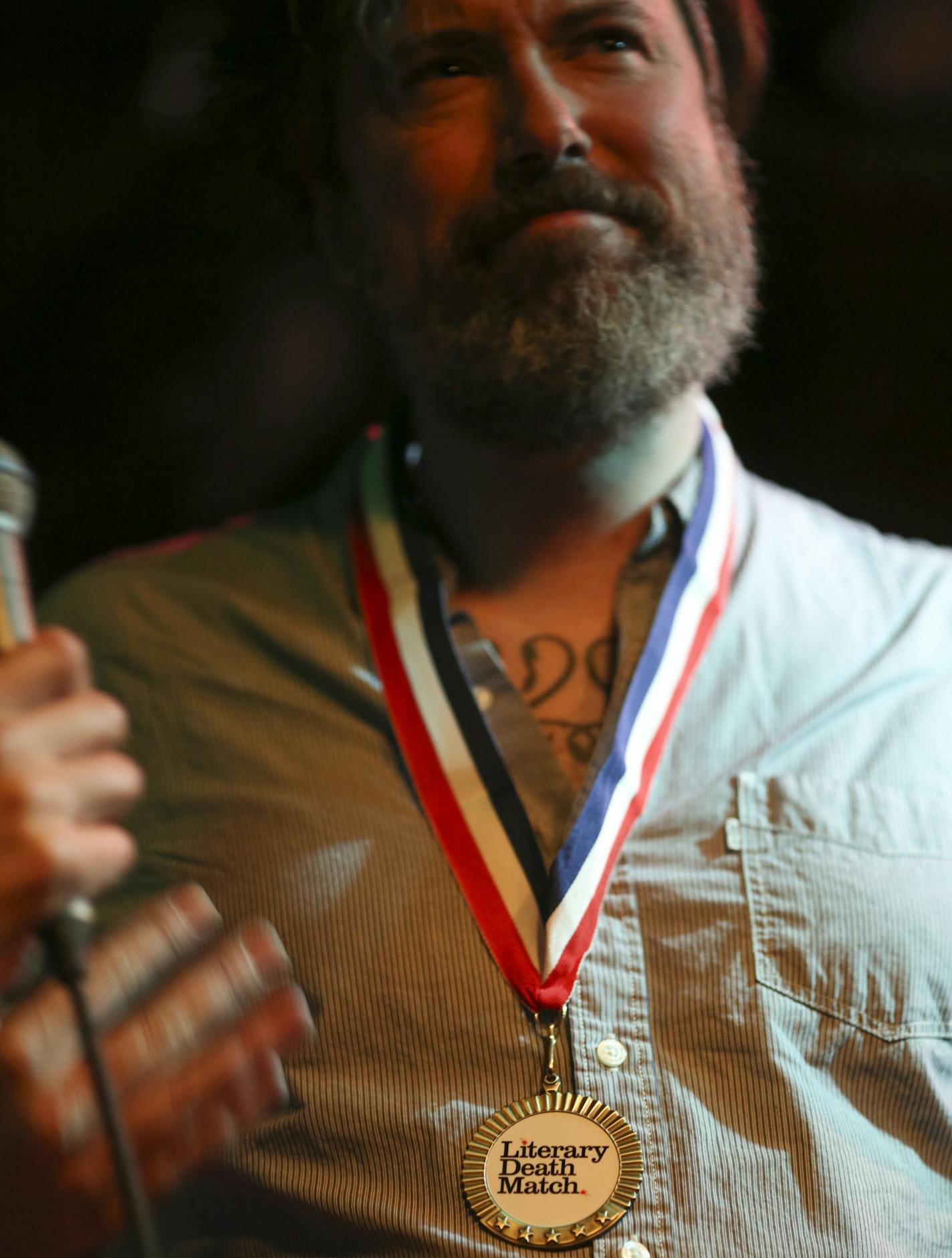 Author Mark Doten won the Literary Death Match championship medal Wednesday night at Nomad World Pub. ] JEFF WHEELER &#xef; jeff.wheeler@startribune.com One of the off-site events at the start of the AWP Conference & Bookfair was the Literary Death Match Wednesday night, April 8, 2015 at Nomad World Pub in Minneapolis. Four writers read their work and were judged by a panel of three all star judges.