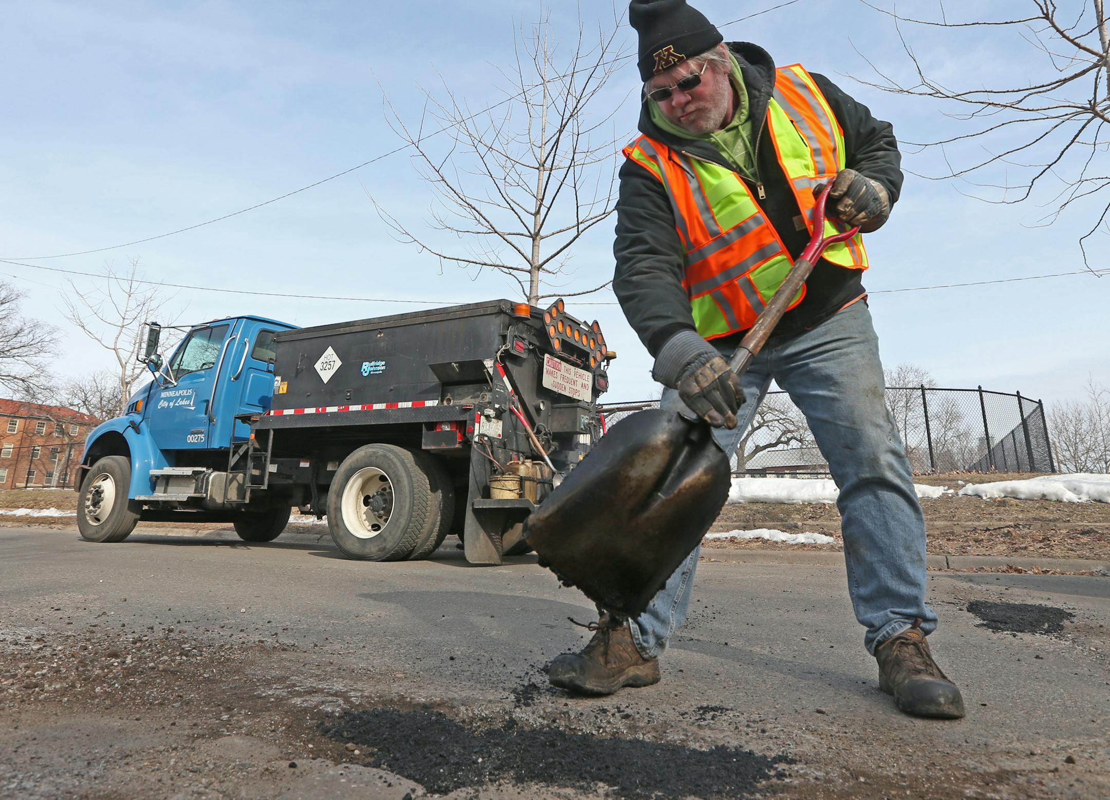 (left to right) Minneapolis city worker Mike Flaferty patched potholes near Clinton Ave South and 25th Street in Minneapolis on 3/26/14.] Bruce Bisping/Star Tribune bbisping@startribune.com Ben White, Mike Flaferty/source.