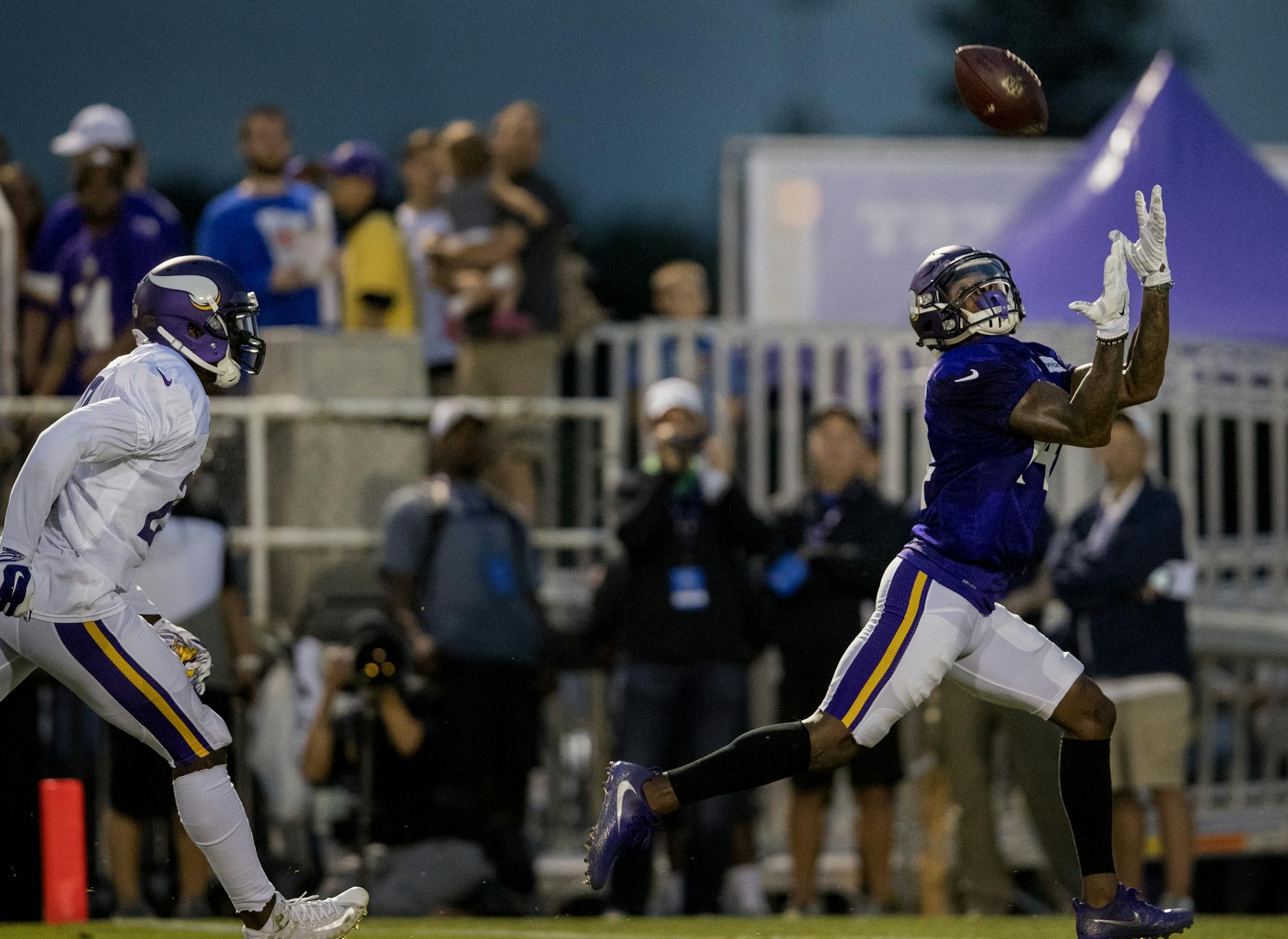 Stefon Diggs (14) caught a pass while being covered by Xavier Rhodes (29) during practice at Blakeslee Stadium in Mankato.
