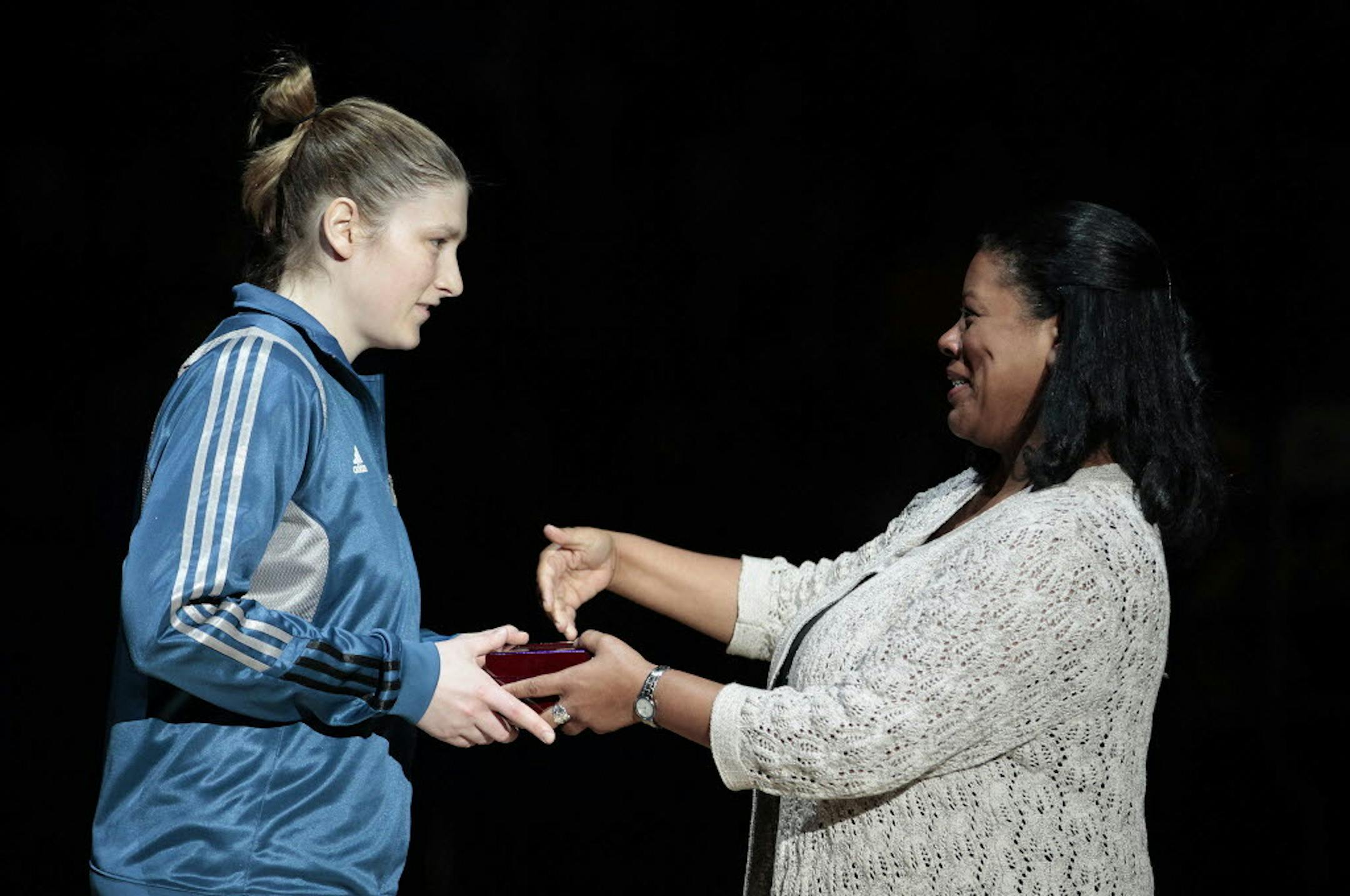 Minnesota Lynx guard Lindsay Whalen, left, receives her 2011 WNBA Championship ring from WNBA Commissioner Laurel Richie before a basketball game against the Phoenix Mercury, Sunday, May 20, 2012, in Minneapolis. (AP Photo/Stacy Bengs)