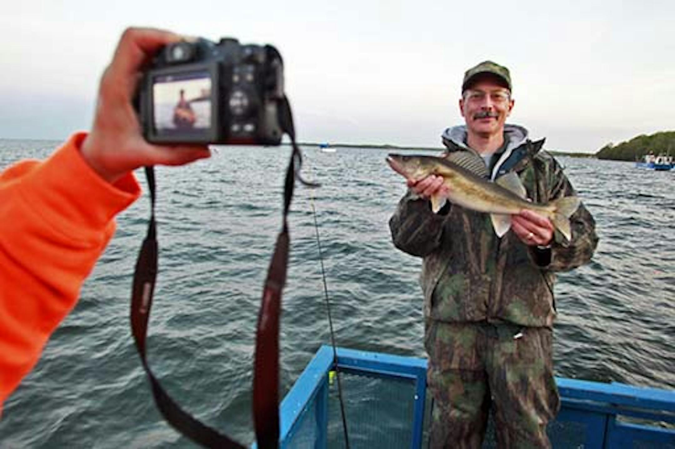 Marlin Levison• mlevison@startribune.com Fishing from a 50-foot launch boat operated by Twin Pines Resort on Lake Mille Lacs. IN THIS PHOTO:Brad Otremba of St. Paul had his 20-inch walleye recorded on video.