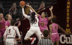 Gophers center Klarke Sconiers (25) forced Wisconsin Badgers forward Imani Lewis to miss a shot at William Arena on Sunday. The Gophers defeated Wisco
