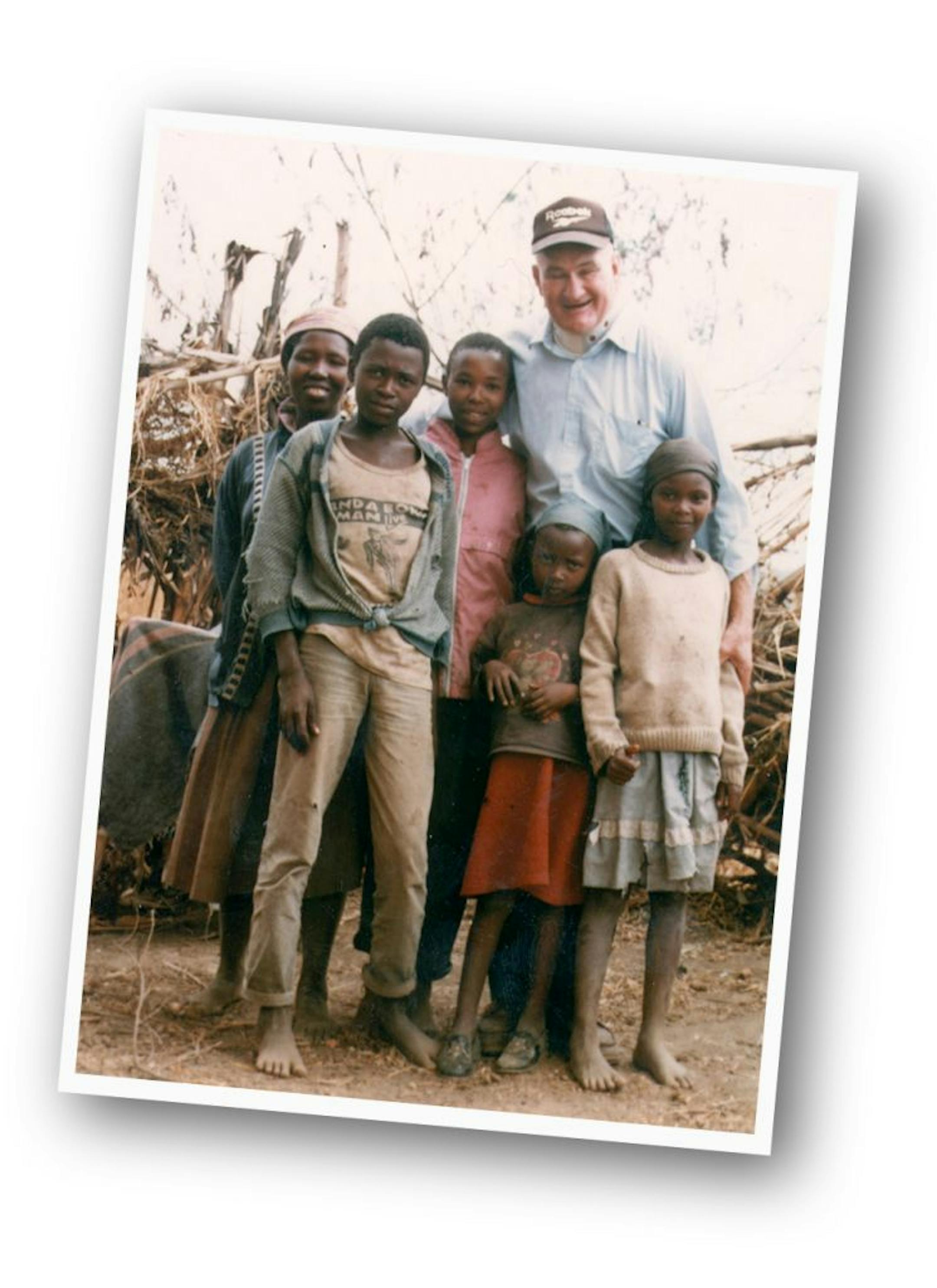 Minnesota priest John Kaiser, with a family in Kenya. Kaiser died in 2000 under mysterious circumstances.