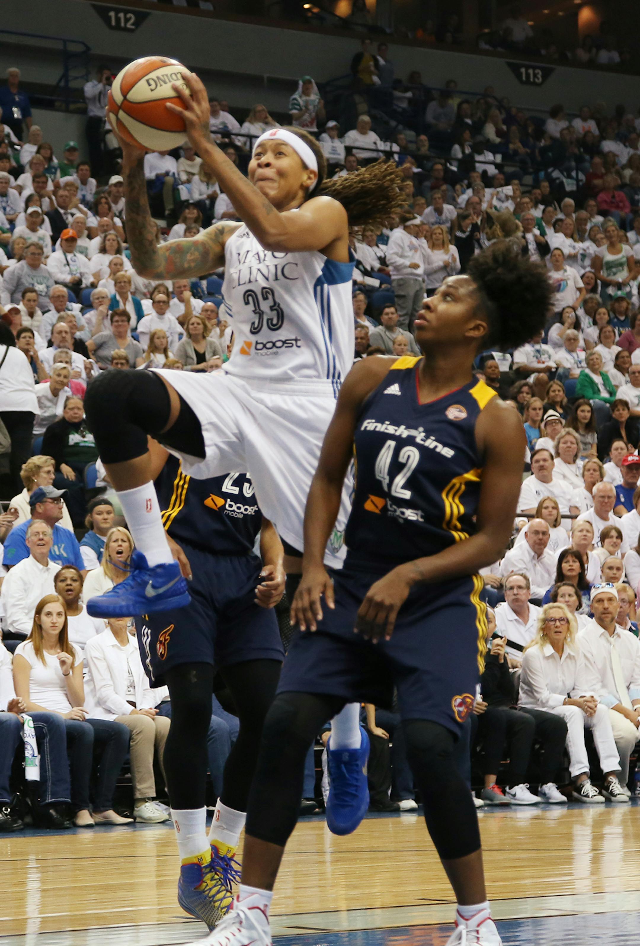Minnesota Lynx guard Seimone Augustus (33) shoots during the first half against Indiana Fever guard Shenise Johnson (42).