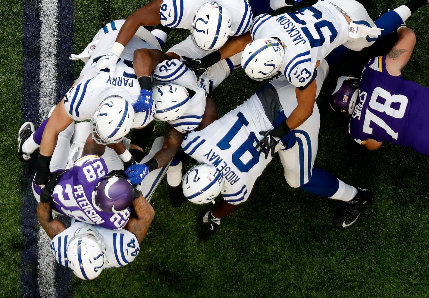 Minnesota Vikings running back Adrian Peterson was tackled by a group of Colts defenders in the first quarter. The carry was Peterson's first after returning from a knee injury. ] CARLOS GONZALEZ cgonzalez@startribune.com - December 18, 2016, Minneapolis, MN, US Bank Stadium, NFL, Minnesota Vikings vs. Indianapolis Colts