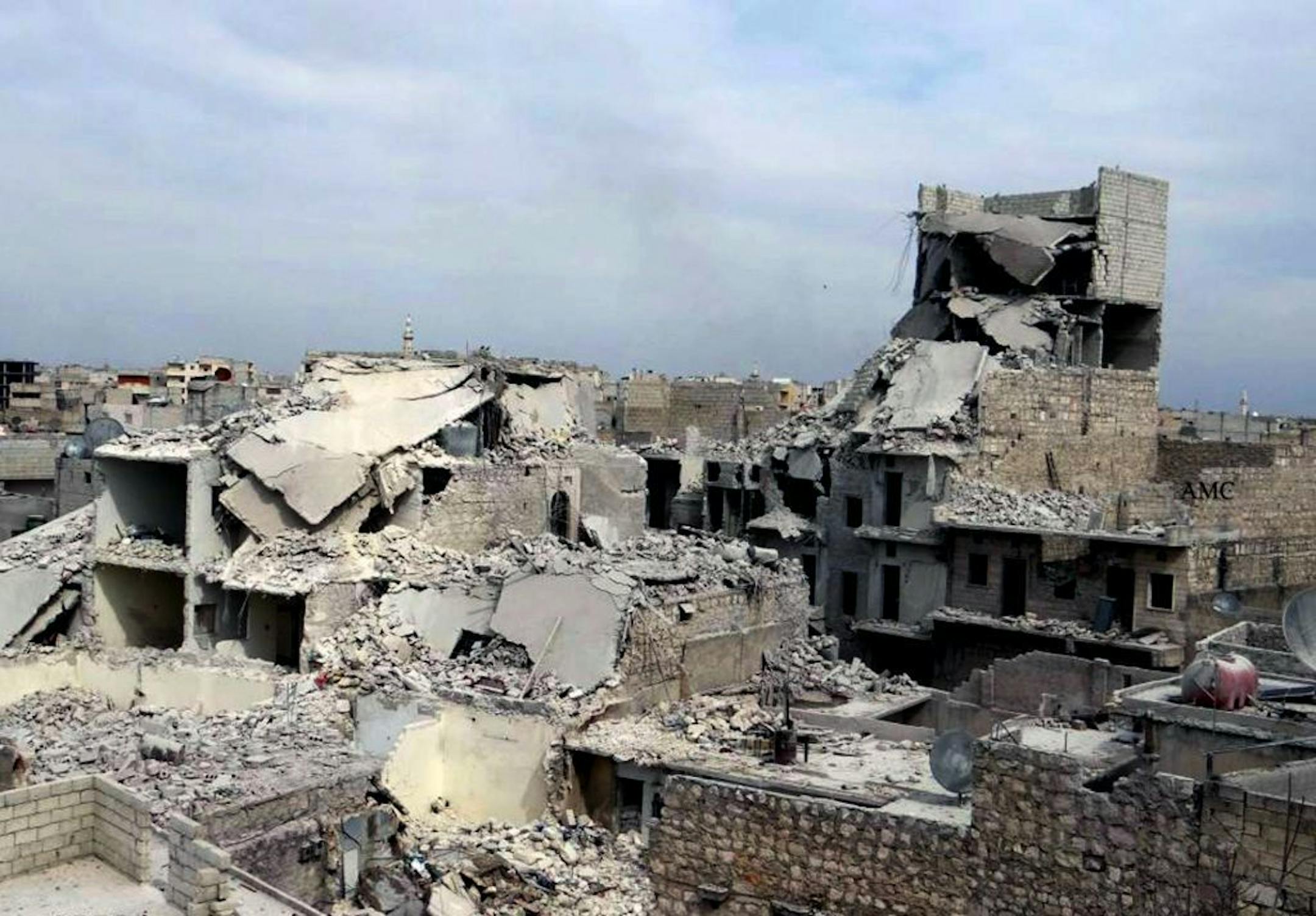 This citizen journalism image provided by Aleppo Media Center AMC which has been authenticated based on its contents and other AP reporting, shows destroyed homes in a government airstrike and shelling, in the neighborhood of Marjeh in the northern city of Aleppo, Syria, Thursday, April. 11, 2013. A U.S.-based rights group on Thursday accused Syria of war crimes by indiscriminate and sometimes deliberate airstrikes against civilians, killing at least 4,300 people since last summer.