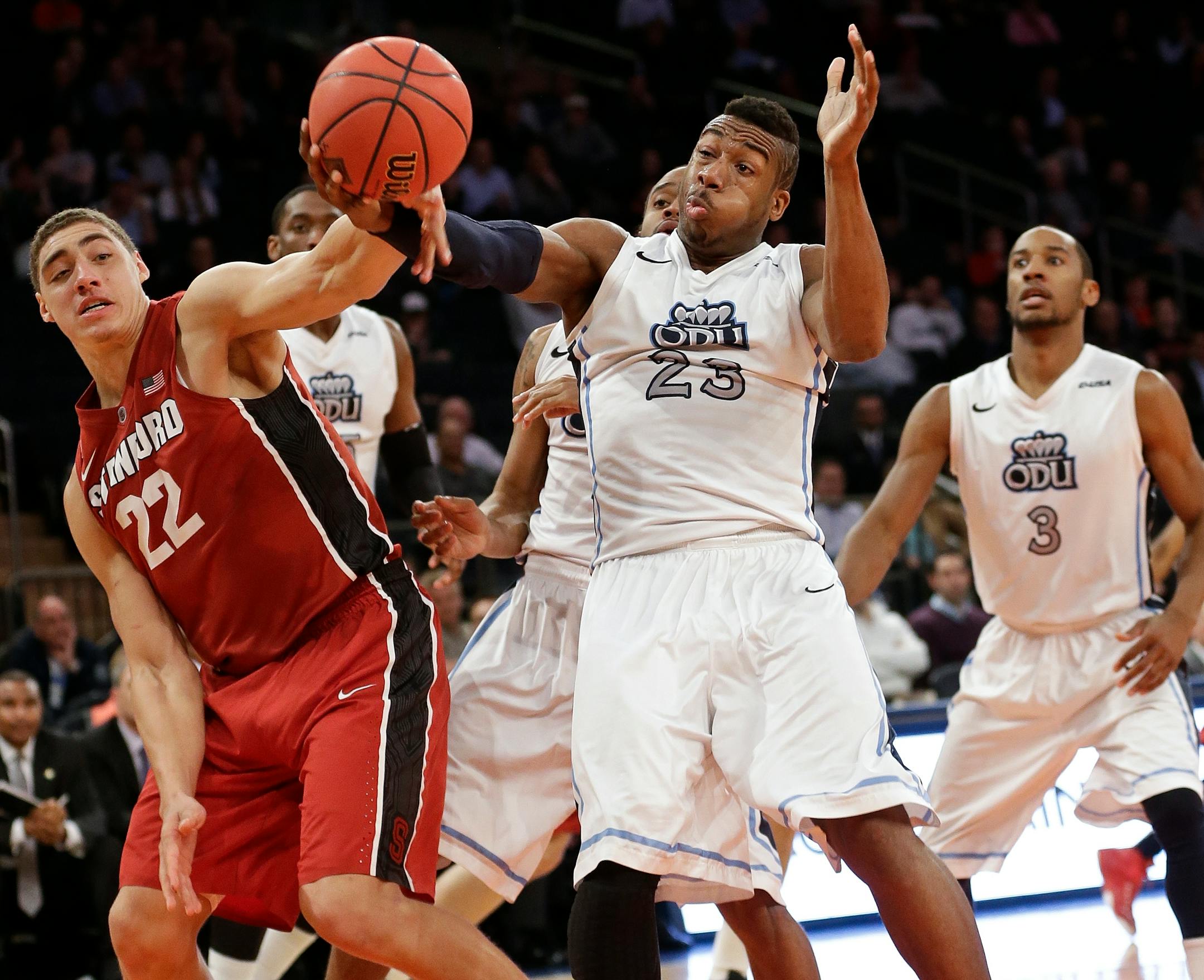Stanford's Reid Travis (22) and Old Dominion's Richard Ross (23) vie for control of the ball during the second half of a semifinal at the NIT college basketball tournament Tuesday, March 31, 2015, in New York. Stanford won 67-60. (AP Photo/Frank Franklin II)