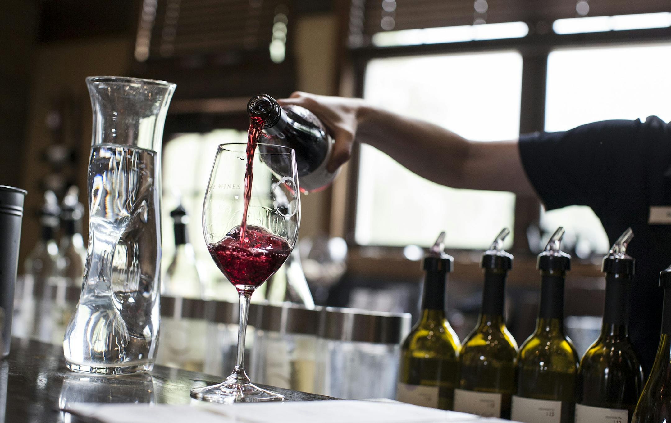 A glass of Marquette Rose is poured for a customer in the tasting room at Chankaska Creek Ranch and Winery in Kasota.