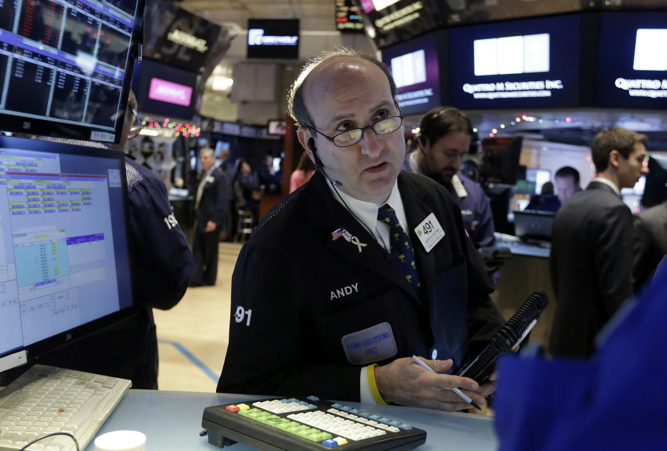 Trader Andrew Silverman works on the floor of the New York Stock Exchange Tuesday, Jan. 6, 2015. The U.S. stock market is edging higher in early trading as the price of oil extends its slump. (AP Photo/Richard Drew)