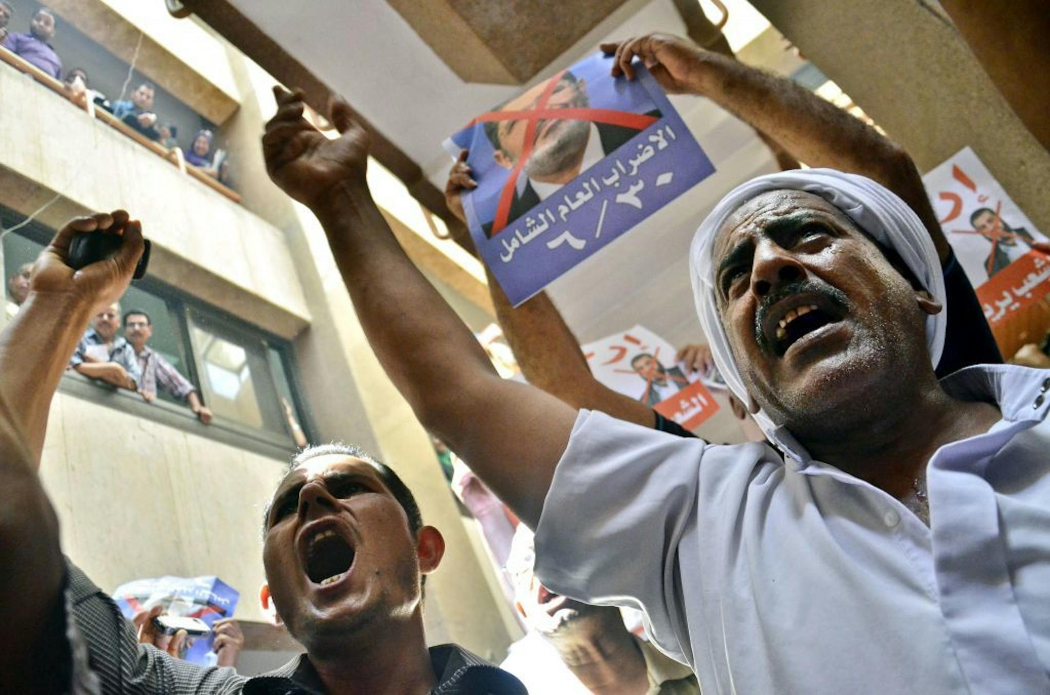 Protesters chant slogans against Egyptian President Mohammed Morsi at a court in Ismailia, 139 Kilometers (86 miles) from Cairo, Egypt, Sunday, June 23, 2013.