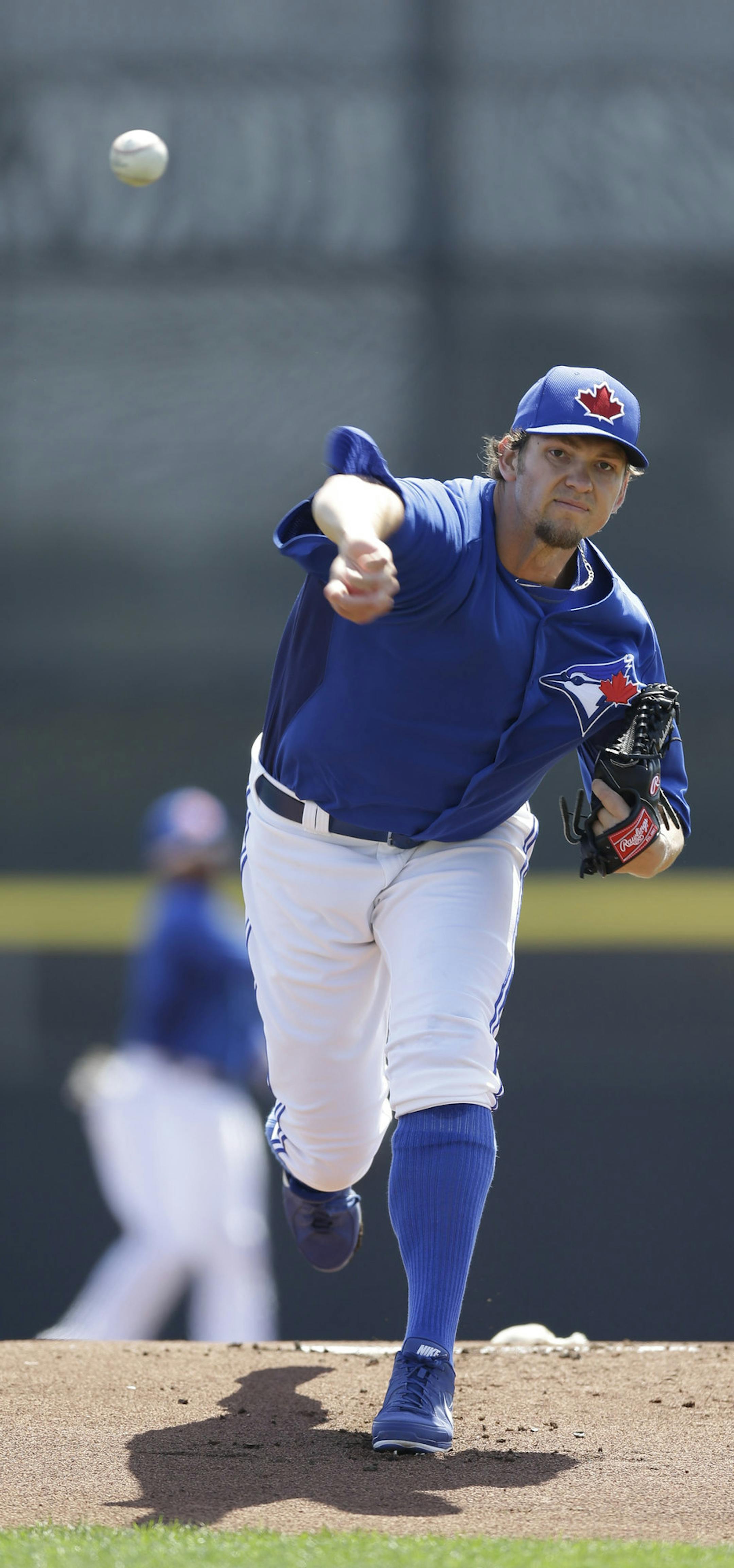 Toronto Blue Jays starting pitcher Josh Johnson (55) delivers a warmup pitch before a spring training baseball game in Dunedin, Fla., Monday, March 25, 2013. (AP Photo/Kathy Willens)