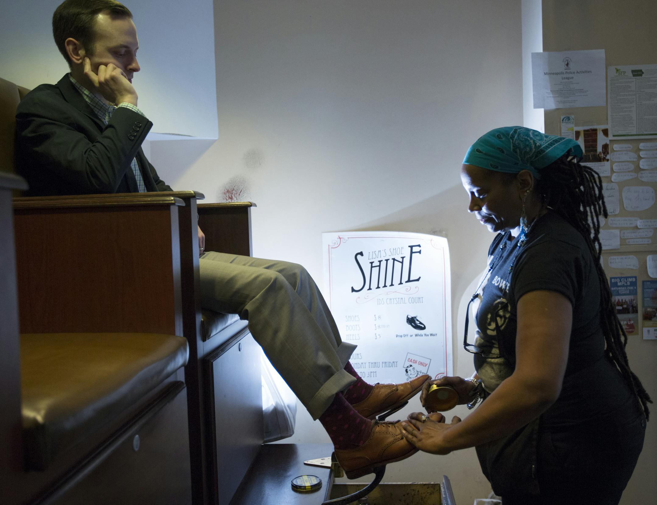 Lisa Fredell applied polish to Sam Rosenbaum’s shoes, top. Her Lisa’s Shoe Shines has been in the IDS Center’s Crystal Court in downtown Minneapolis for 25 years. “This is my calling,” she said.