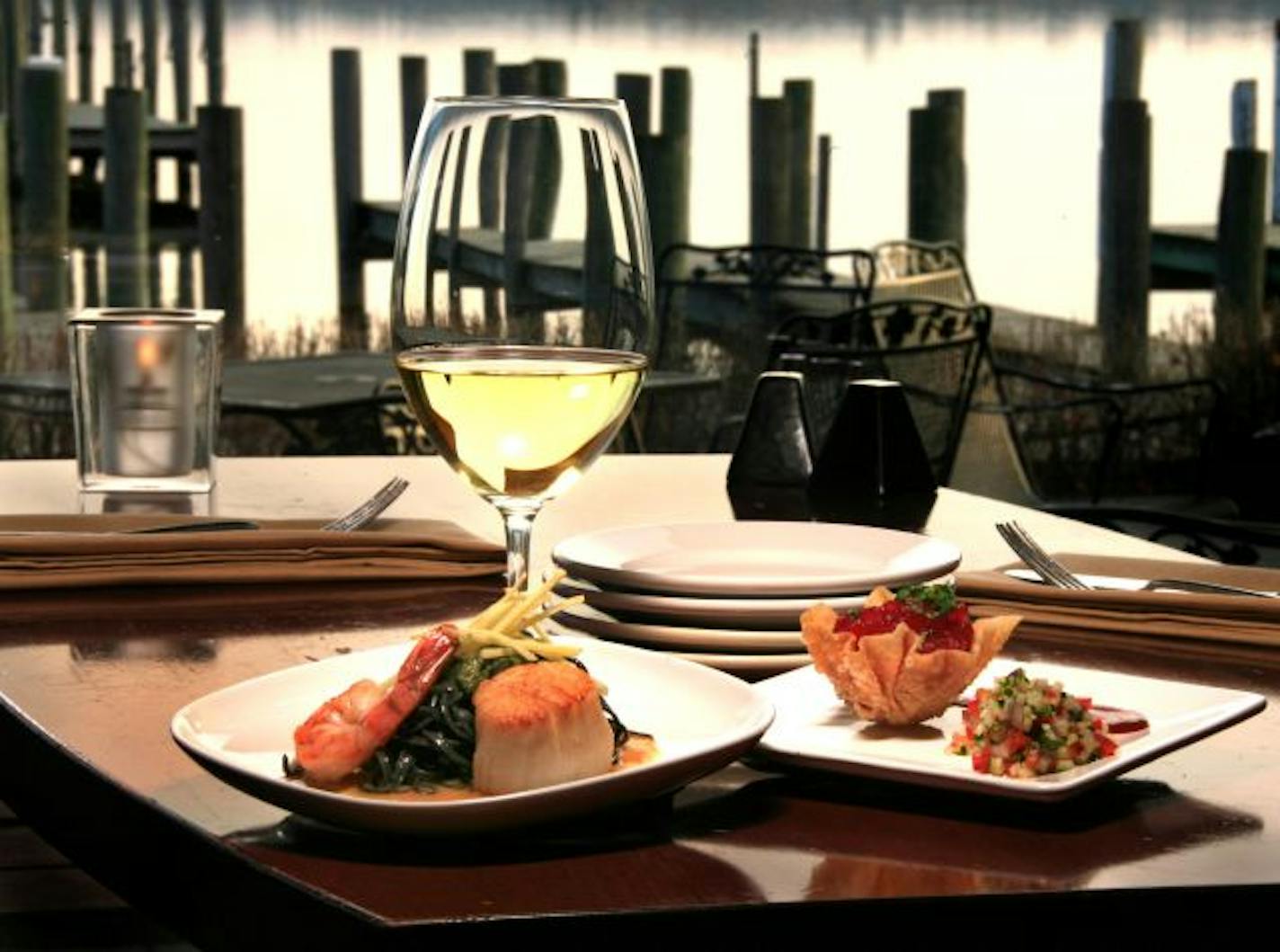 The squid-ink linguini, miso seared shrimp and scallop with ginger gastrique and lemon grass sesame "piston" plate and on the right the tuna tartar with coriander wonton bowl, yuzu mint vinaigrette daikon and cucumber microdiced salad plate.