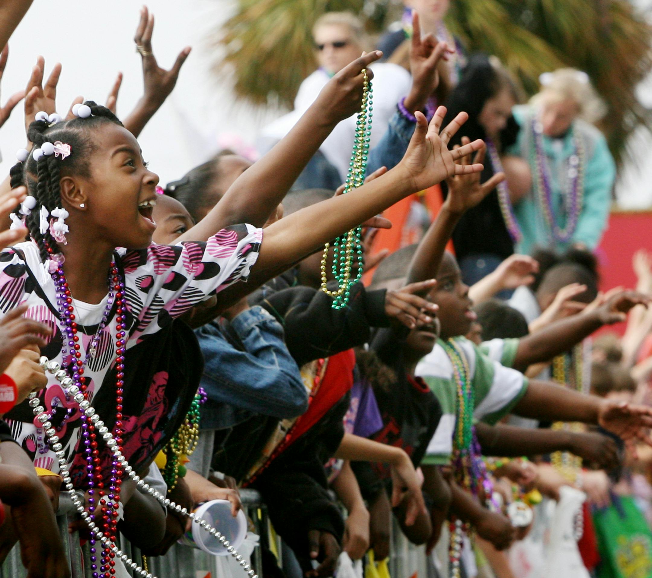 Children call for beads during the Gulf Coast Carnival Association/Neptune Mardi Gras parade in Biloxi, Mississippi, Tuesday, February 5, 2008. (John Fitzhugh/Biloxi Sun Herald/MCT)