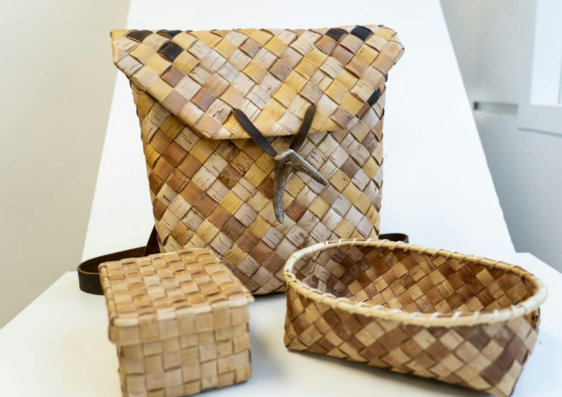 Beth Homa Kraus weaves with locally harvested materials: Backpack, $375; Doreen basket with root rim, $125; birch hinged lidded basket, $125.