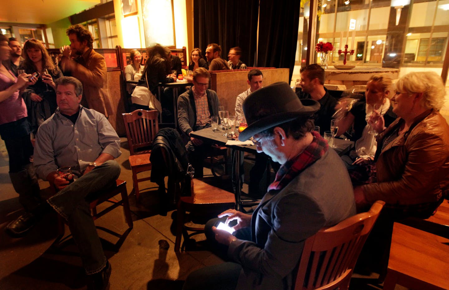 TOM WALLACE â€¢ twallace@startribune.com _ Amsterdam Hall, 6 West 6th St. St Paul. The Amsterdam Bar and Hall is the new music venue and bar/restaurant in St Paul. Minneapolis Musician Adam Levy checks his phone while waiting in between bands. [ _ Assignments #20019952A_ September 29, 2011_ SLUG: restaurant1013_ EXTRA INFORMATION: Name(CQ) from the