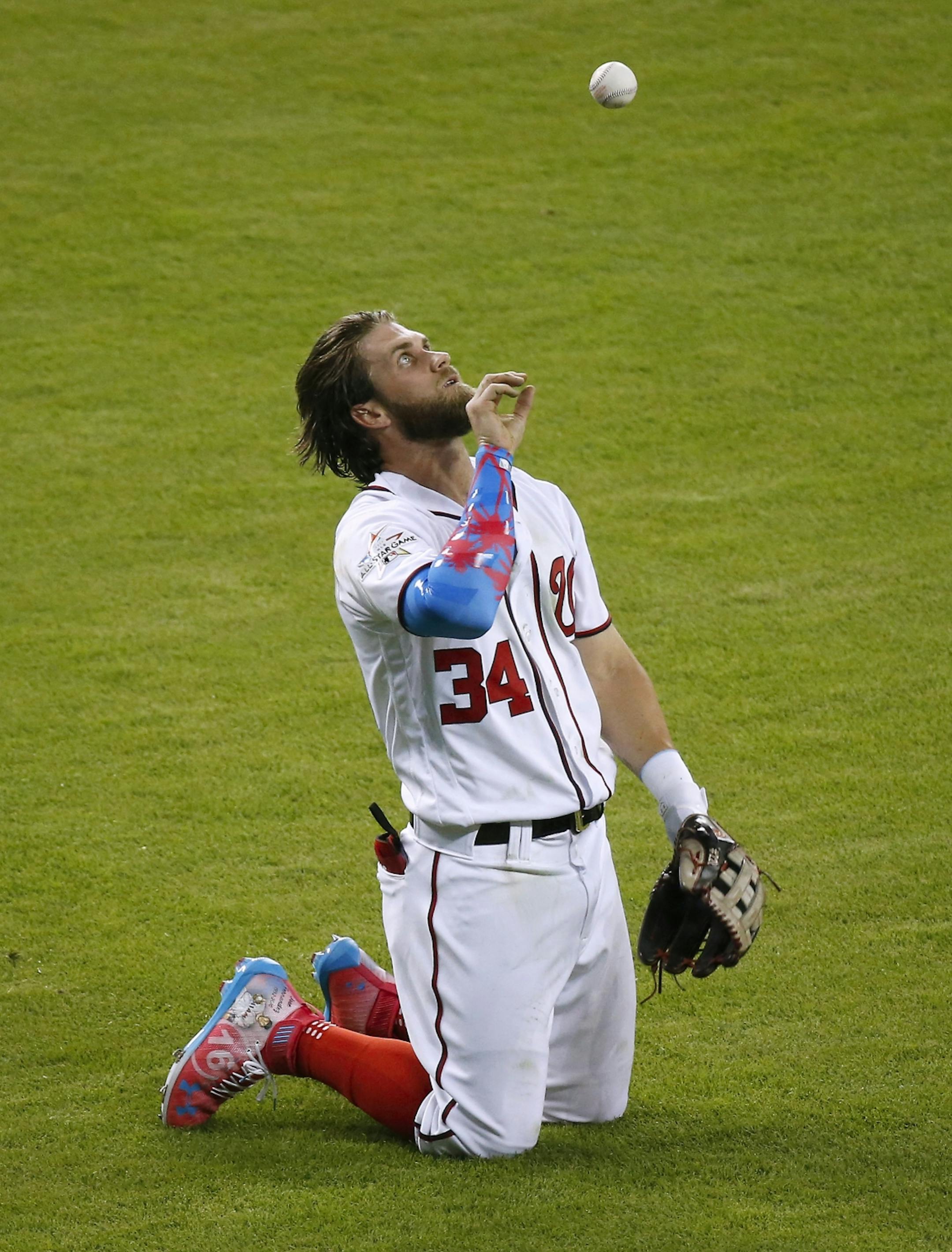 The National League's Bryce Harper of the Washington Nationals reacts after making a catch on a fly ball by American League catcher Salvador Perez of the Kansas City Royals during the second inning of the MLB All-Star Game on Tuesday, July 11, 2017, at Marlins Park in Miami, Fla.