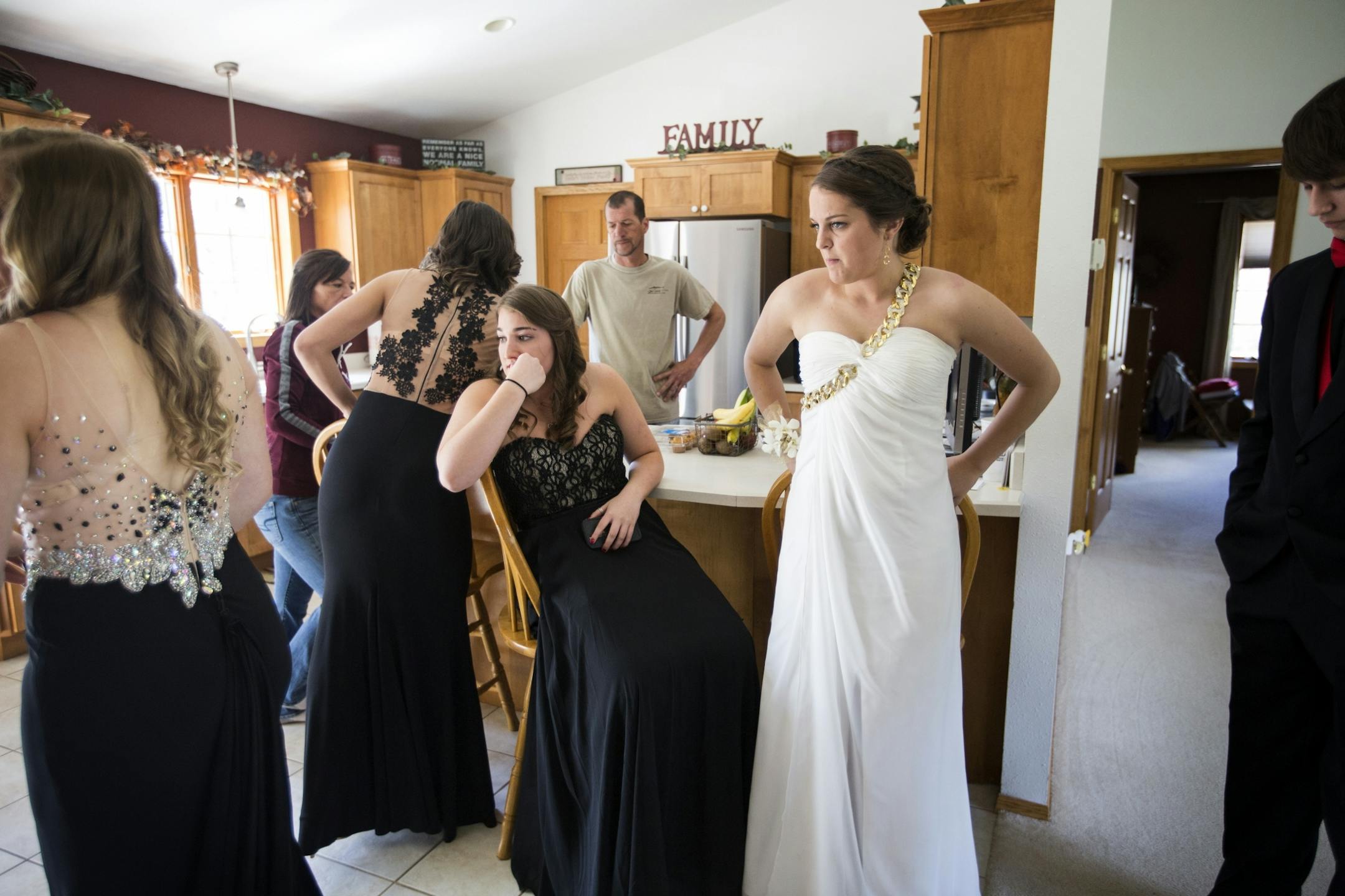 All seniors at Eveleth-Gilbert High School, Logan Rozinka, center, and Kiersten Jackson, right in white, wait to leave for prom at their friend Baylee Hilfers house in Fayal.