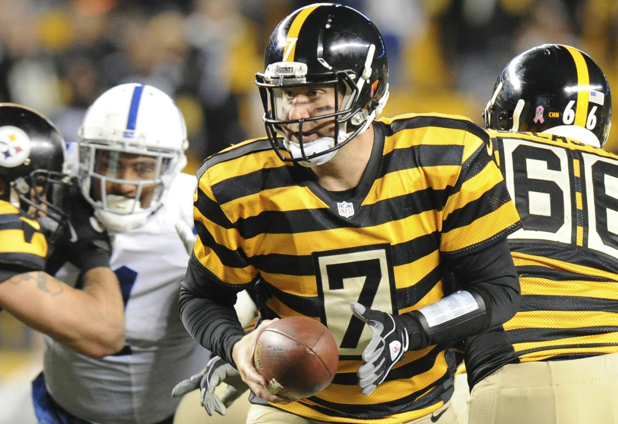 Pittsburgh Steelers quarterback Ben Roethlisberger (7) hands off in the fourth quarter of the NFL football game against the Indianapolis Colts, Sunday, Oct. 26, 2014 in Pittsburgh. The Steelers won 51-34. With this win, Roethlisberger became the fourth quickest quarterback to 100 wins in the first 150 games of his career at 100 wins against 50 losses. He is behind Tom Brady, Joe Montana, and Terry Bradshaw. (AP Photo/Don Wright)