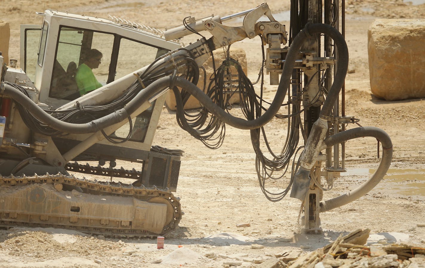 A worker drills at the Jefferson Quarry for limestone extraction in Mankato, Minn., on Thursday, July 11, 2013. Mankato Kasota Stone, a 125-year-old company providing distinctive limestone for architecture ranging from middle class homes to Target Field, closed in June. ] (ANNA REED/STAR TRIBUNE) anna.reed@startribune.com (cq)