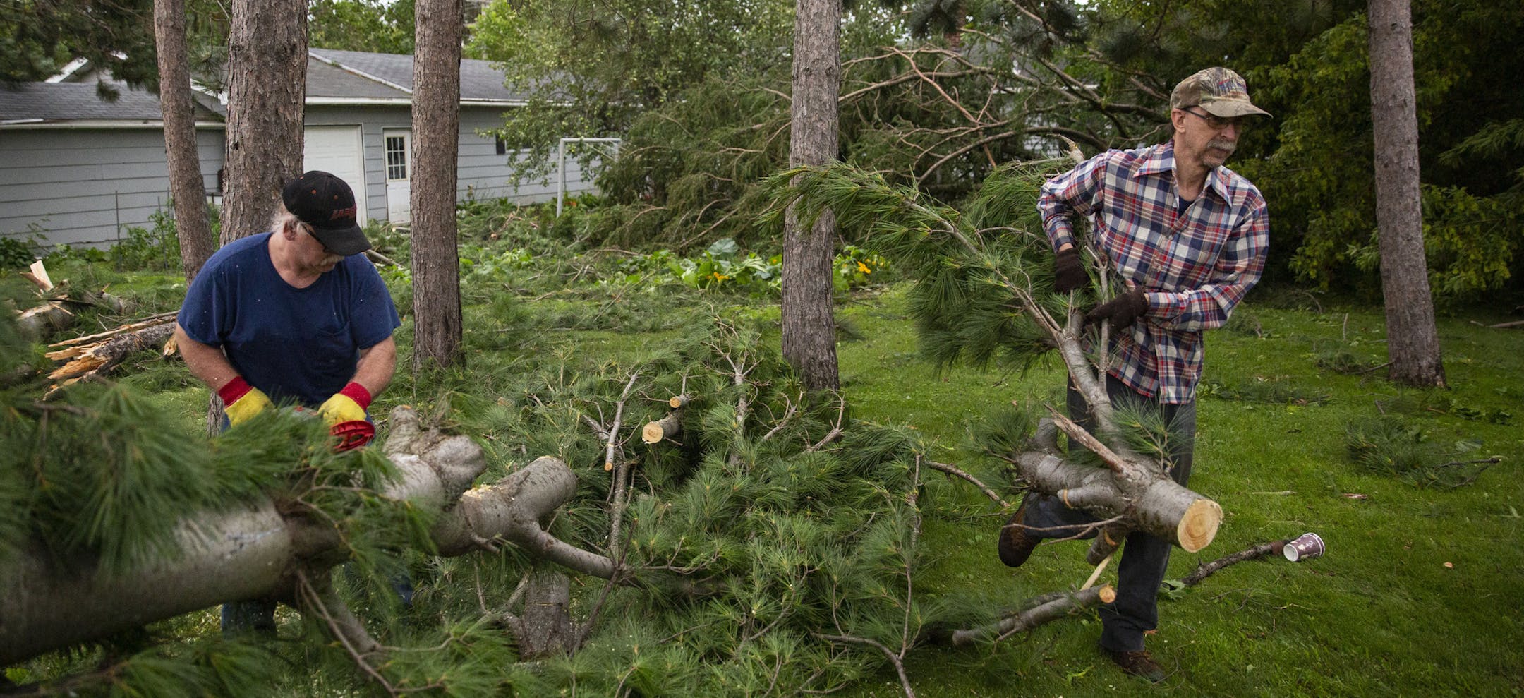 (Left) Roger and Wendell Hatalla cut up and removed debris left from the storm. ALEX KORMANN &#xa5; alex.kormann@startribune.com Tornados ripped through western Wisconsin on Friday evening, hitting towns like Turtle and Lake especially hard. Thousands were left without power and property damages were abundant.