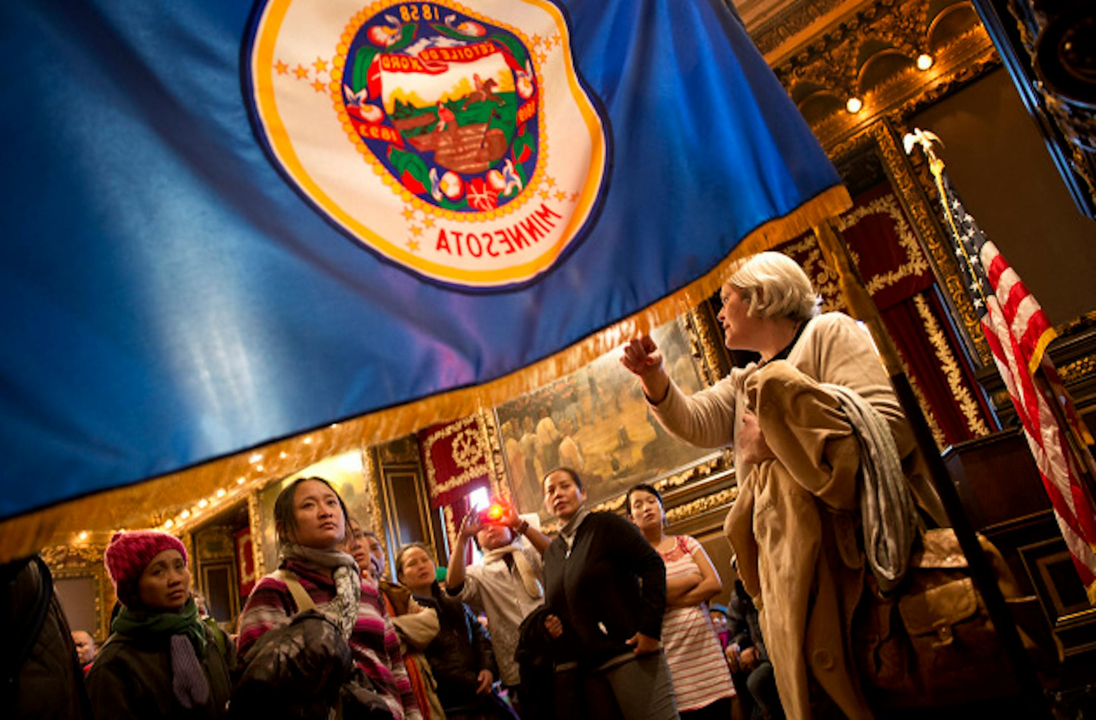 The group looked over the state flag in the governor's reception room.  50 refugees from Burma and Nepal who attend the M.O.R.E. Multicultural School for Empowerment in St. Paul toured the Capitol  Monday, March 4, 2013.  They were there to lobby legislators in the school's district for bills on the minimum wage and education funding.  They also received a first hand civics lesson on who the the Governor is, what the U.S. and state flags represent and how to say the work elevator.   ]   GLEN STUBBE * gstubbe@startribune.com