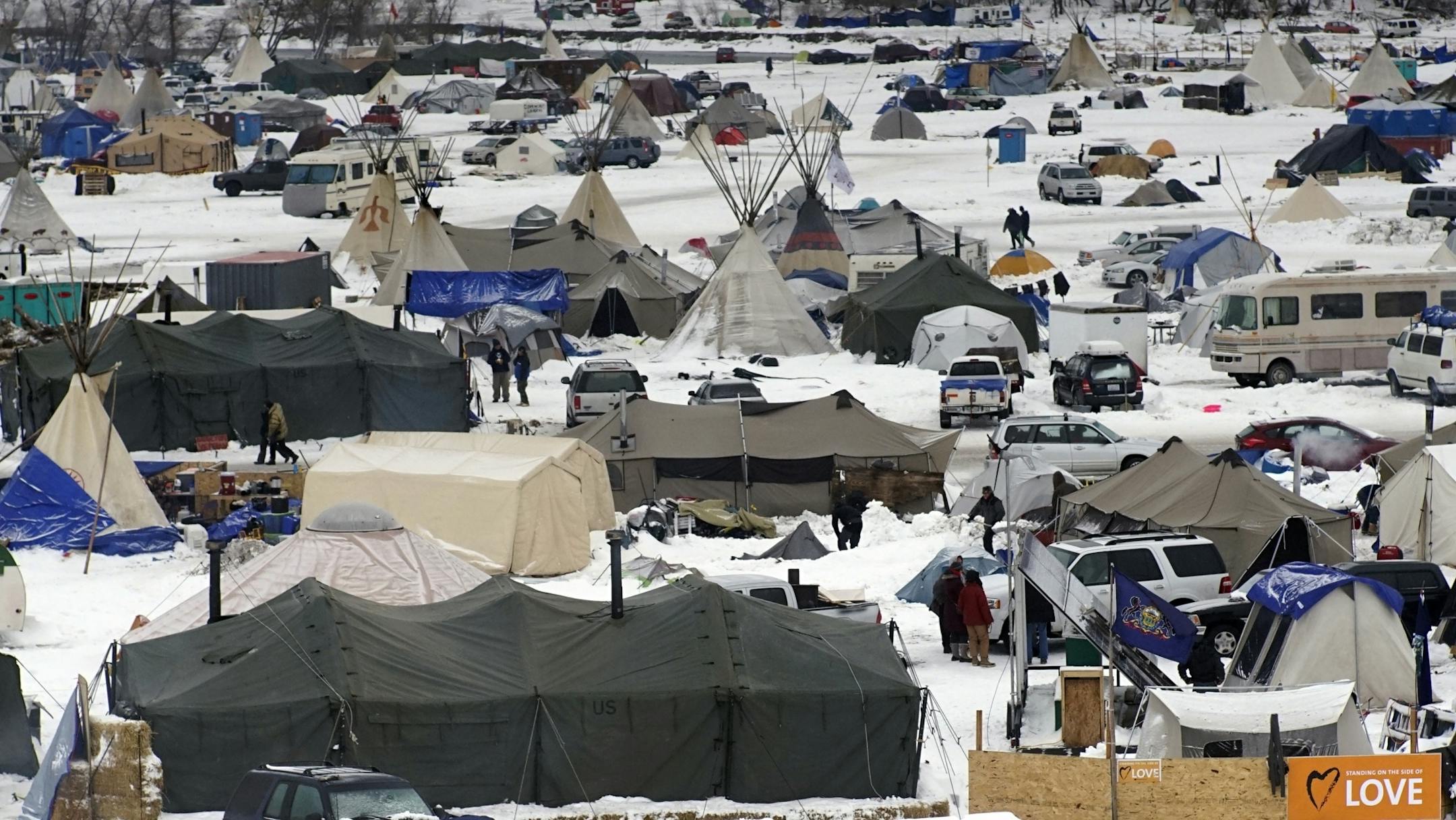 Protesters are adjusting to winter conditions on the prairie by using wood stoves inside army tents and tipis, as well as building wind breaks.