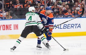 Dallas' Miro Heiskanen (4) and Edmonton's Connor McDavid (97) battle for the puck during second-period action in Game 6 of the Western Conference fina